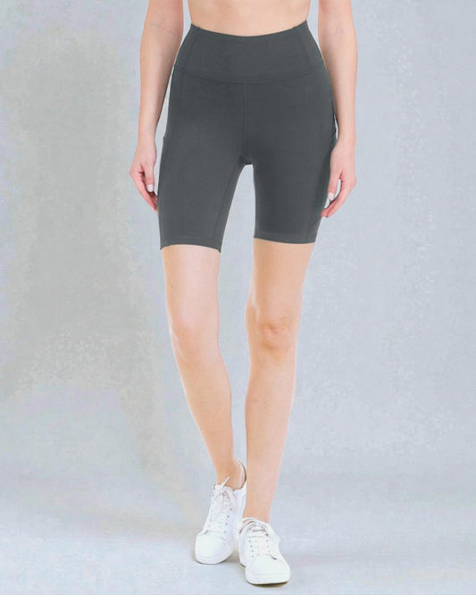 Person wearing dark gray high-waisted shorts on a light gray background