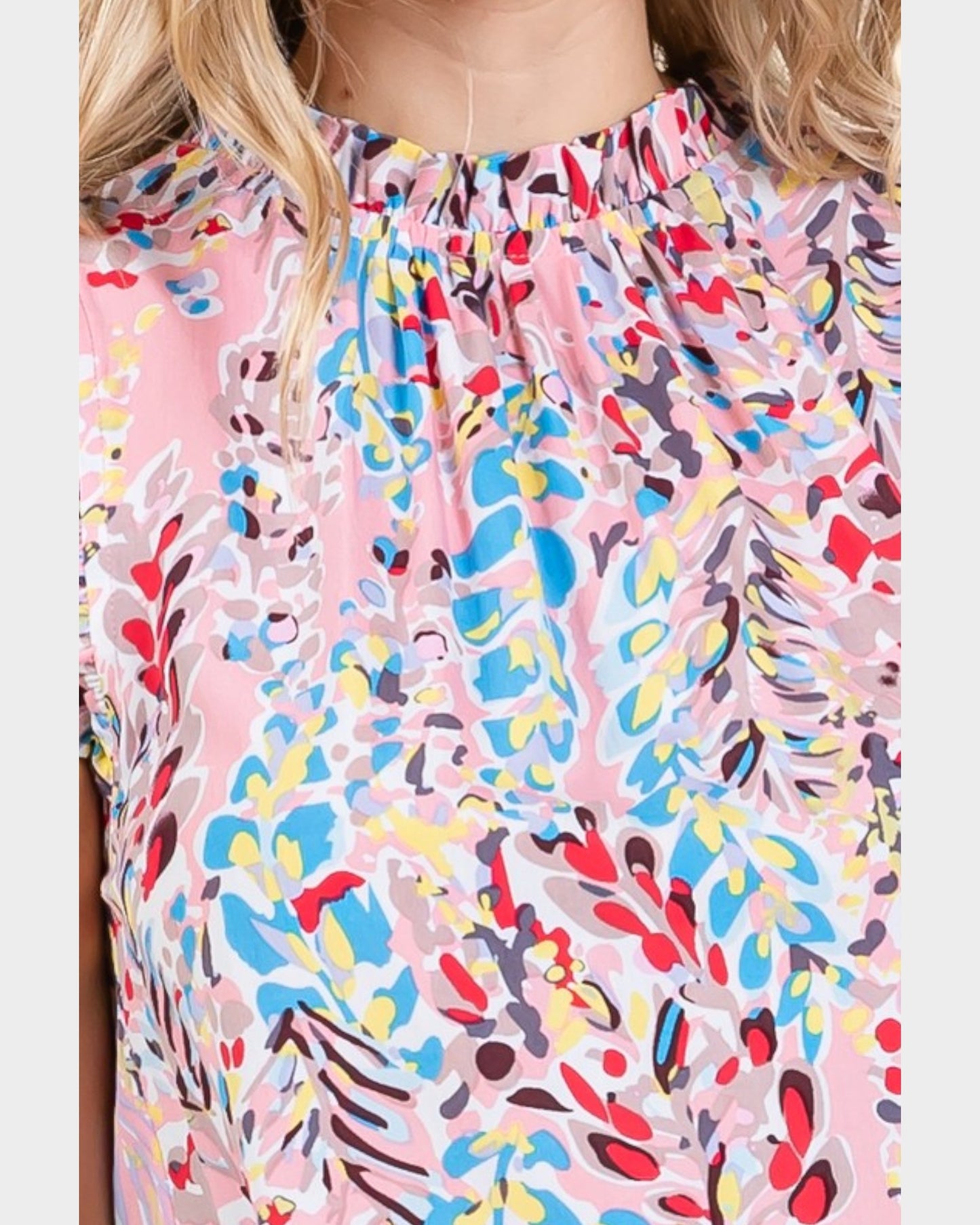 Colorful abstract patterned top worn by a person