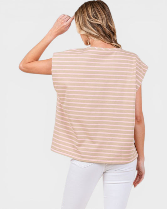 Woman wearing a beige and white striped sleeveless top on a white background