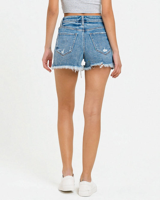 Denim shorts worn by a person on a white background