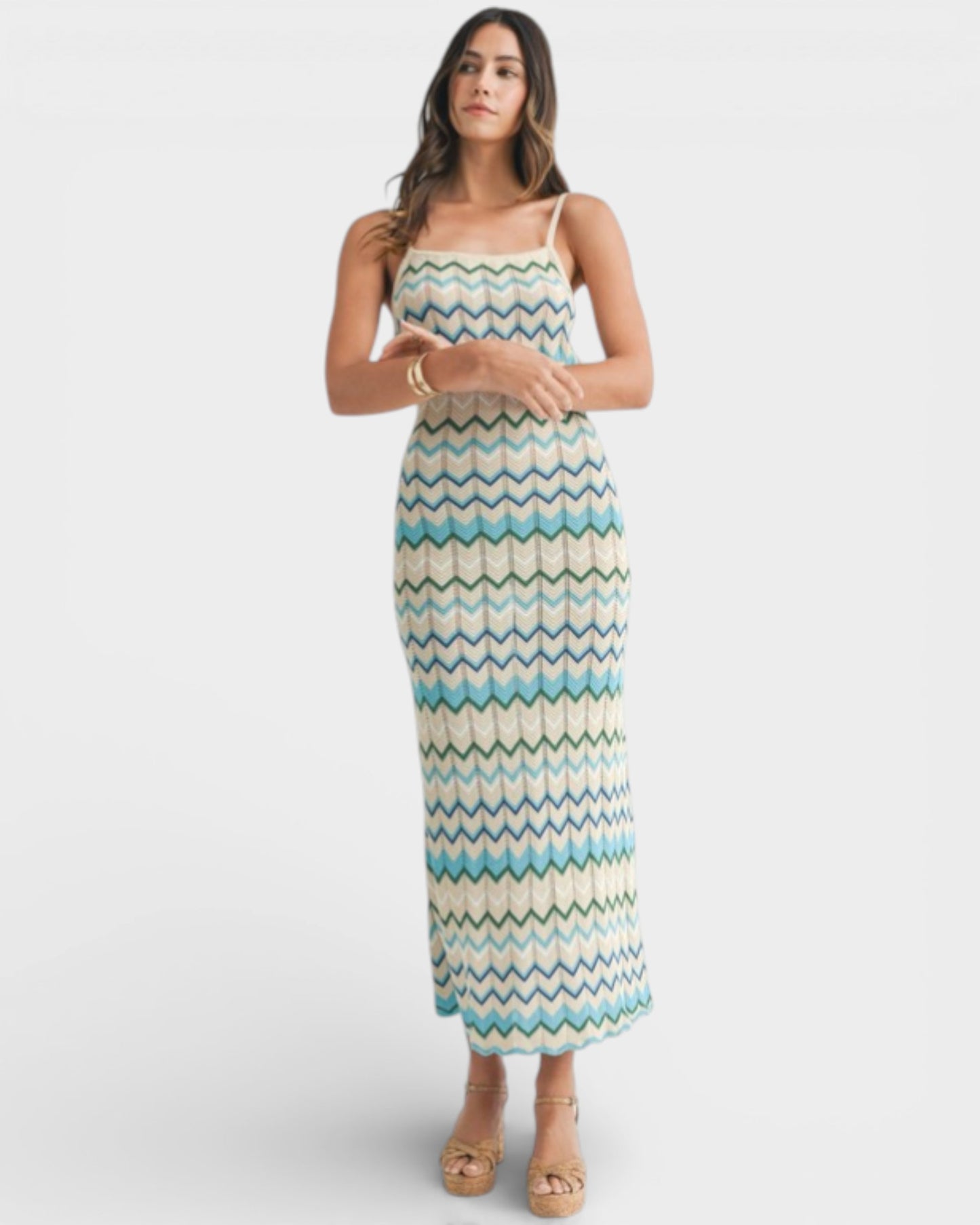 Woman wearing a patterned dress on a white background