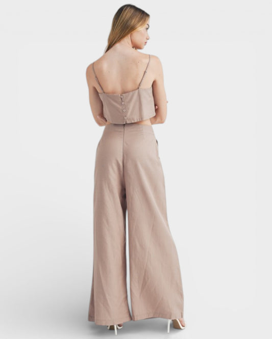 Woman wearing a beige jumpsuit on a white background