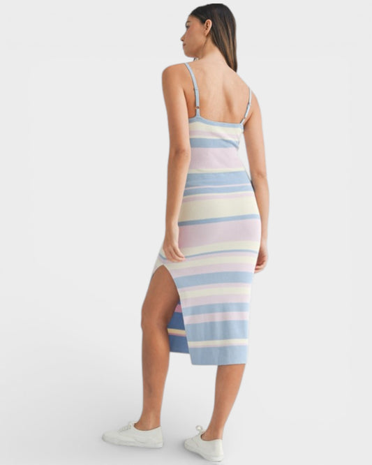 Woman wearing a pastel striped dress with a white background