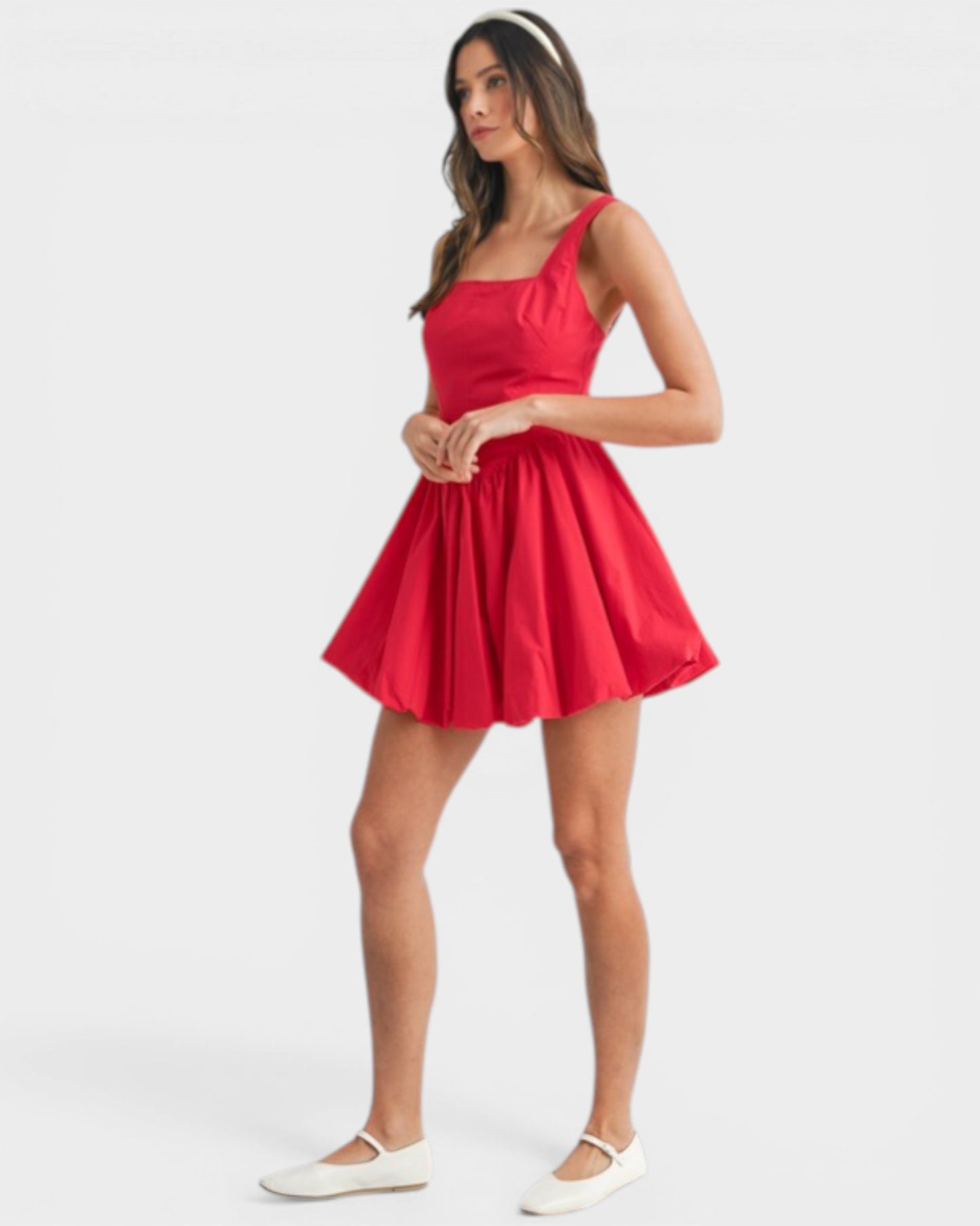 Woman wearing a red dress on a white background