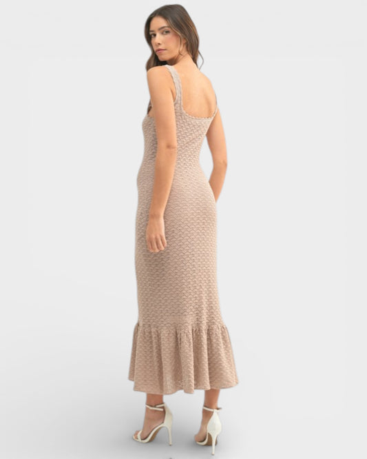 Woman wearing a beige crochet dress on a white background