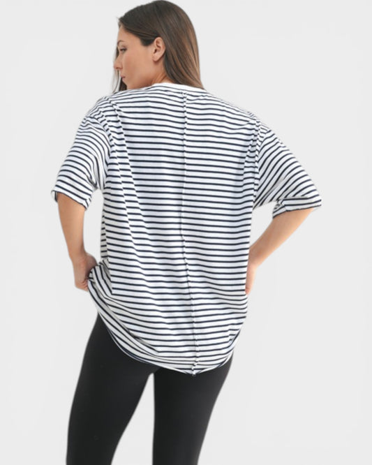 Woman wearing a black and white striped shirt on a plain background