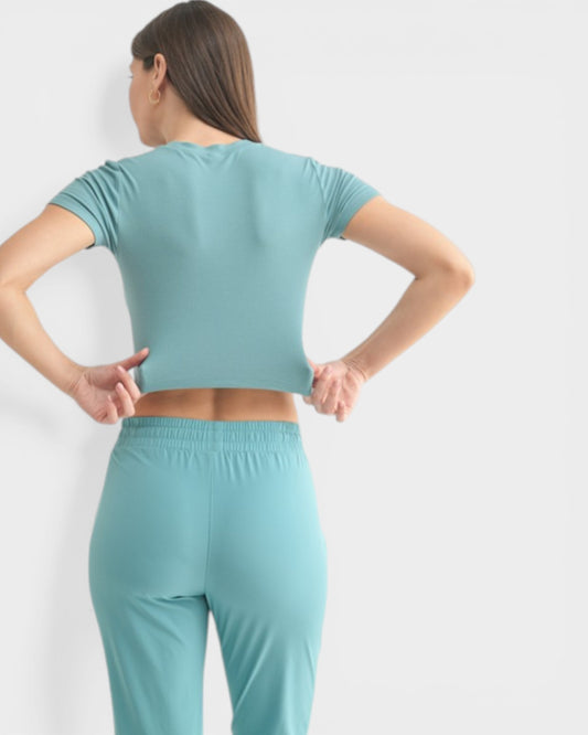Person wearing a teal athletic outfit on a white background