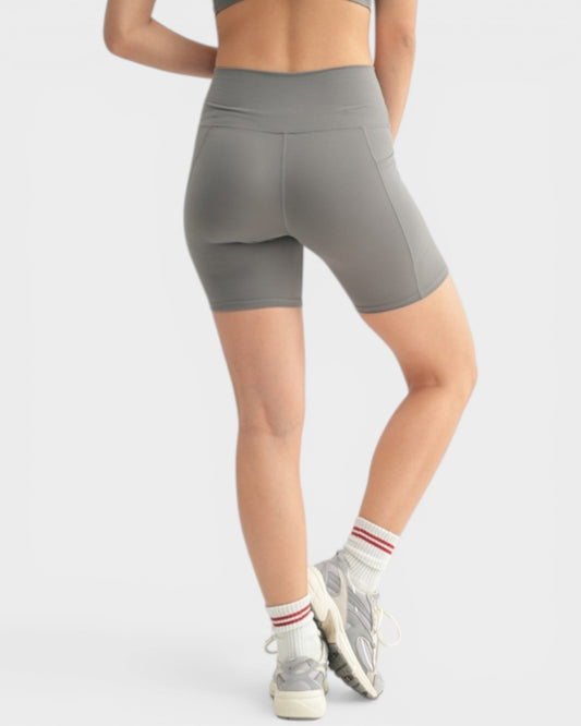 Person wearing gray athletic shorts on a white background