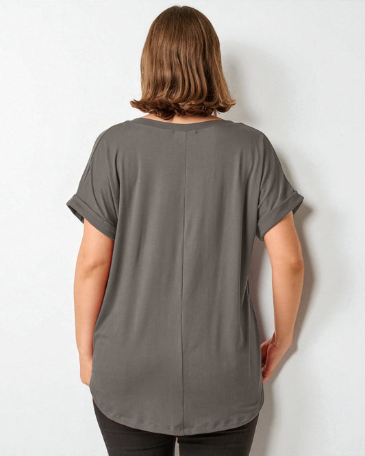 Person wearing a gray t-shirt against a white background