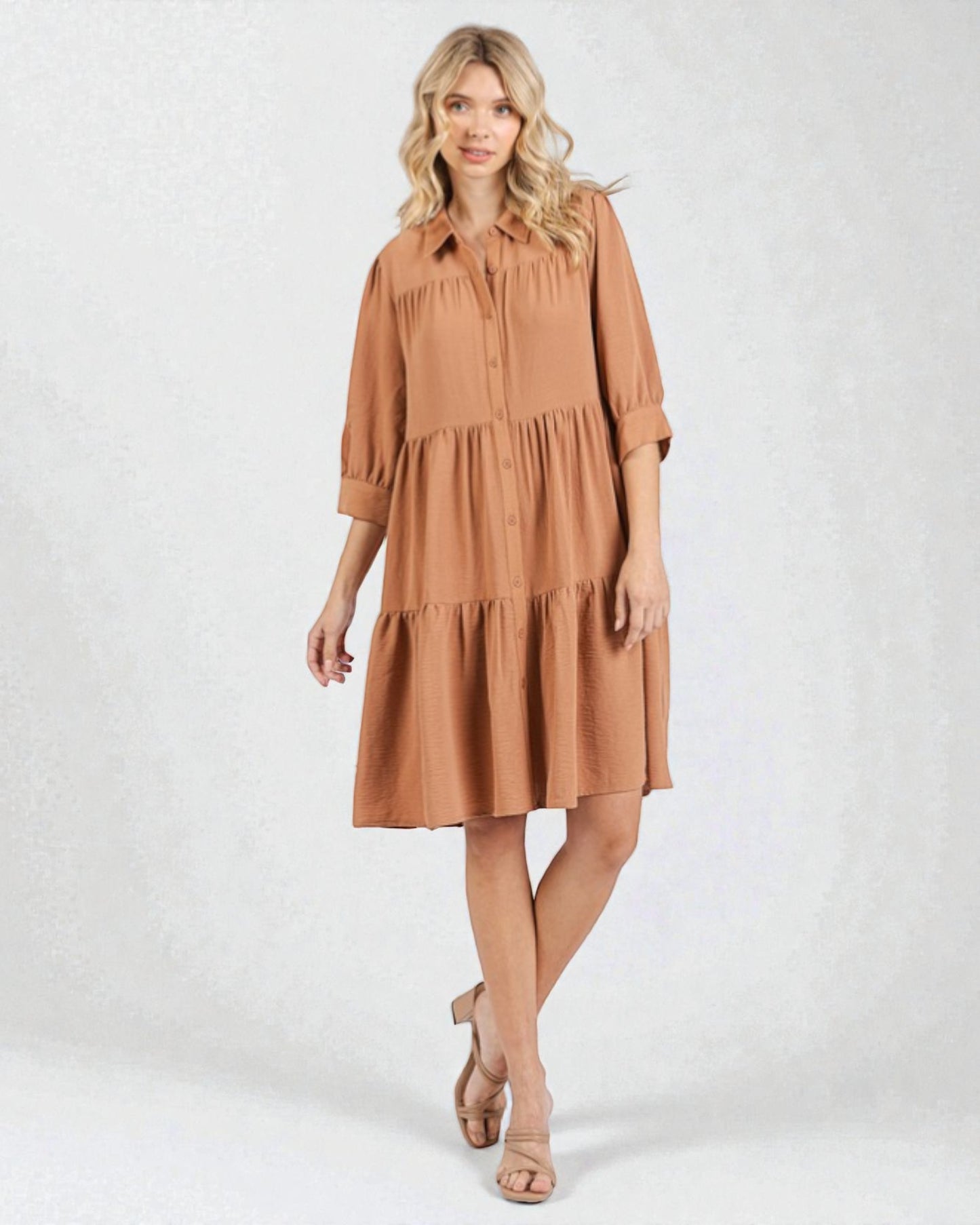 Woman wearing a brown dress on a white background