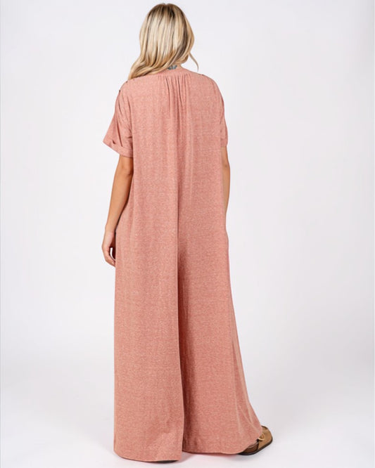 Woman wearing a pink jumpsuit on a white background