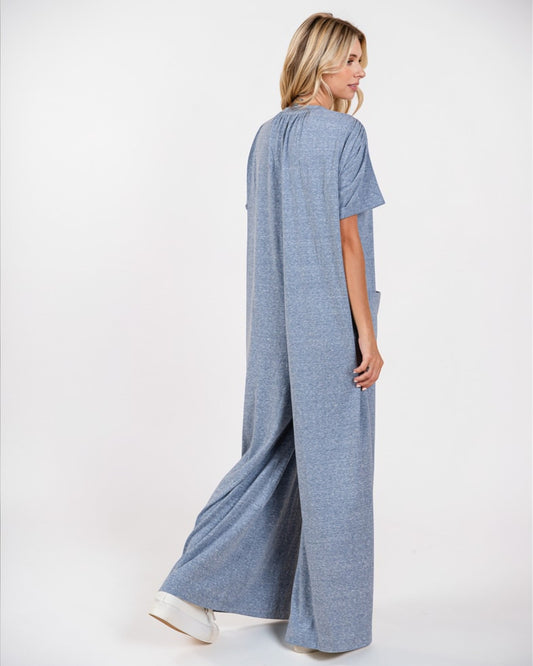 Woman wearing a long blue dress on a white background