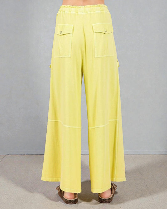 Yellow wide-leg pants on a neutral background