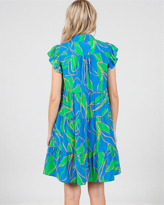 Woman wearing a blue and green patterned dress on a white background