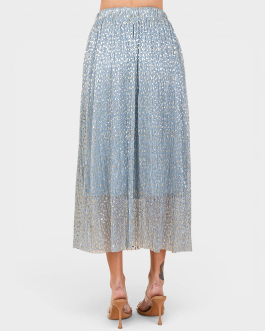 Light blue patterned skirt worn by a person on a white background