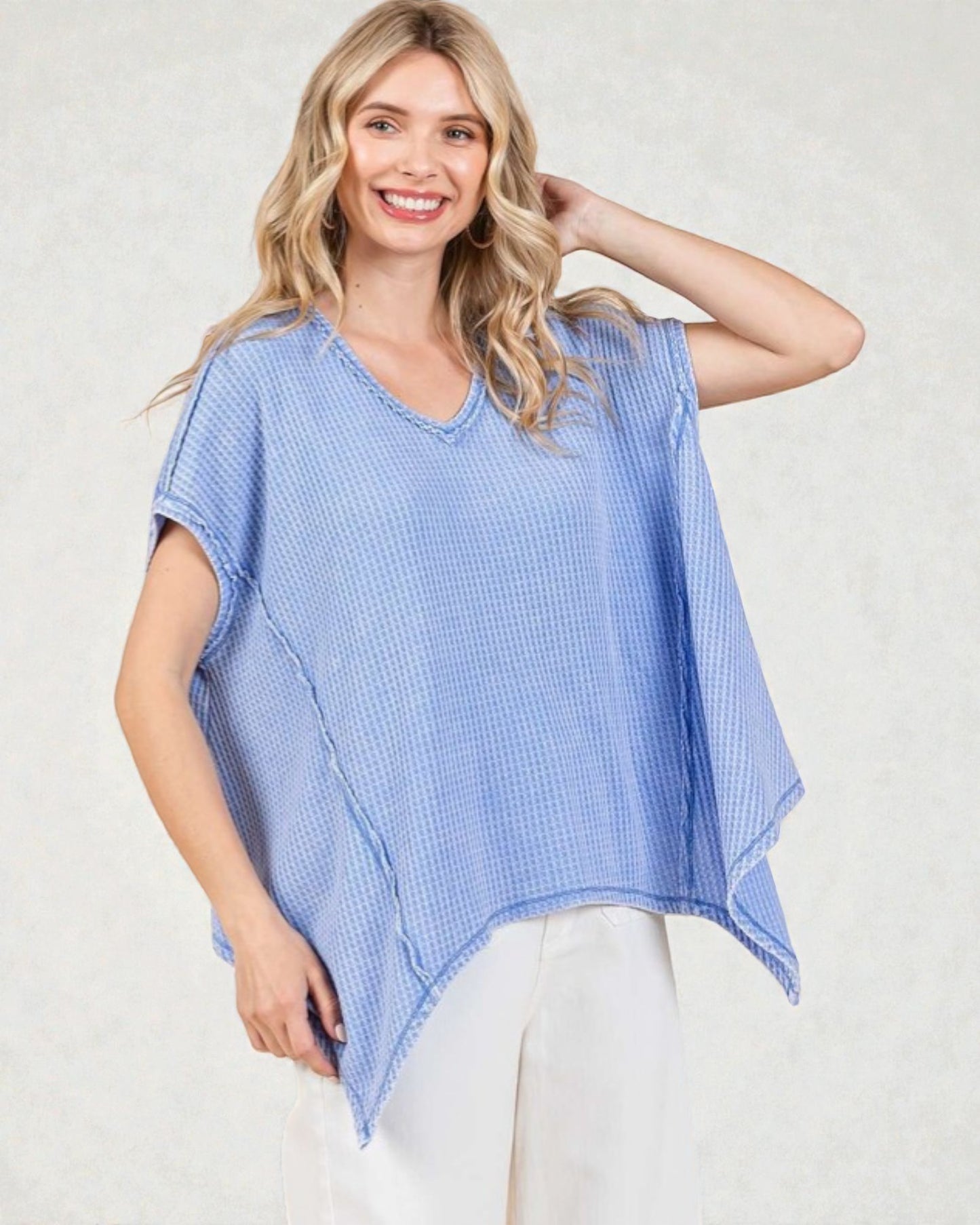 Woman wearing a blue checkered top against a white background