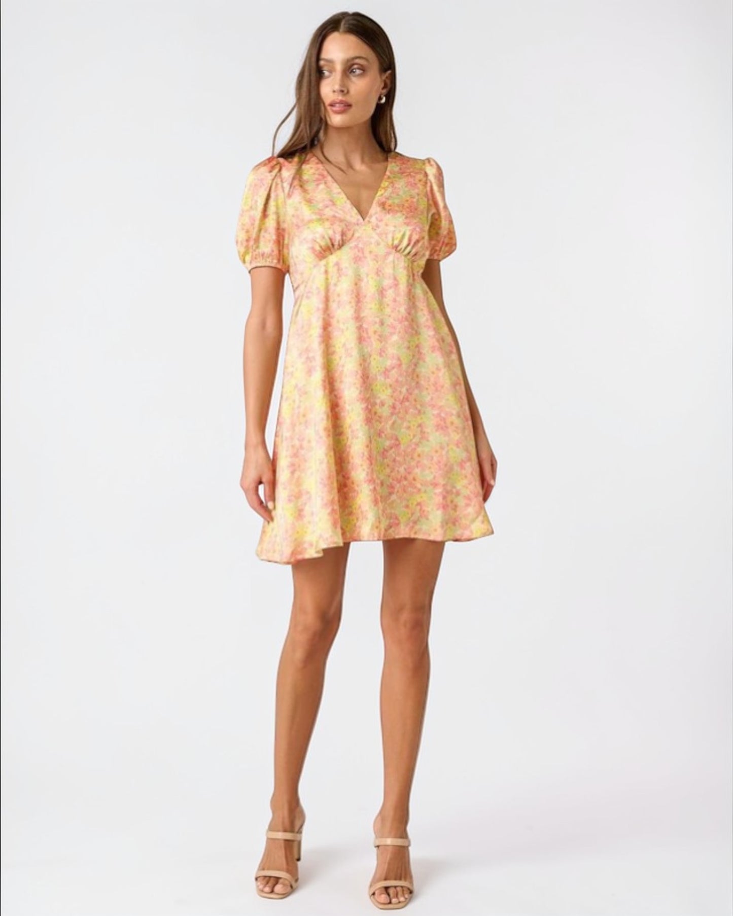 Woman wearing a floral dress on a white background