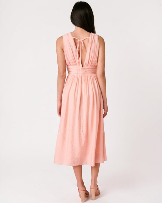 Woman wearing a pink dress with a white background