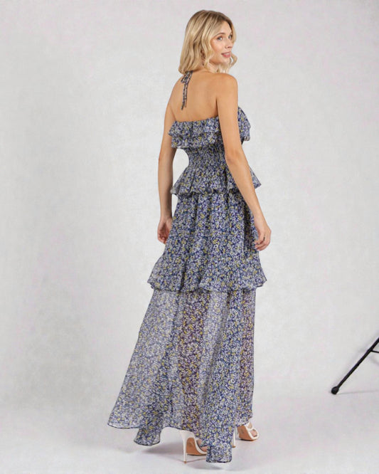 Woman wearing a floral dress with ruffled layers on a white background