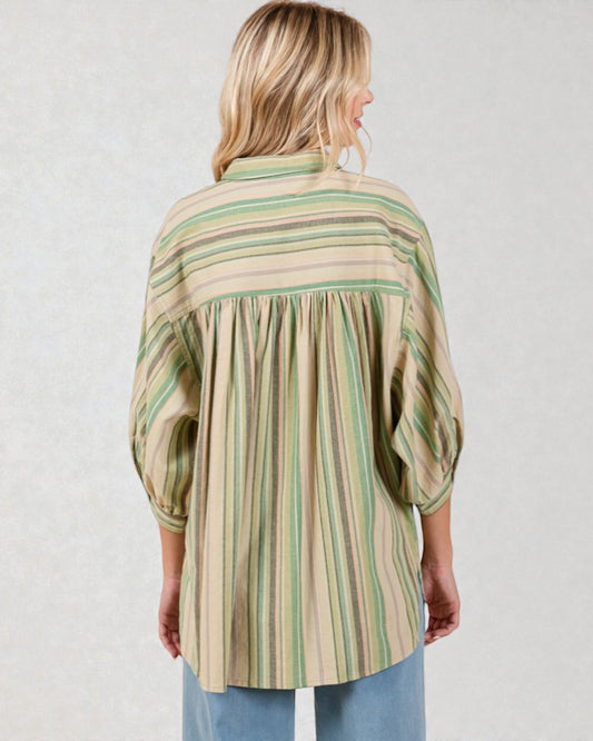 Woman wearing a striped shirt with a plain background