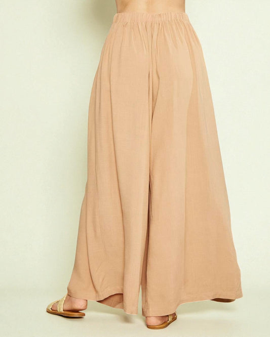Beige wide-leg pants on a neutral background