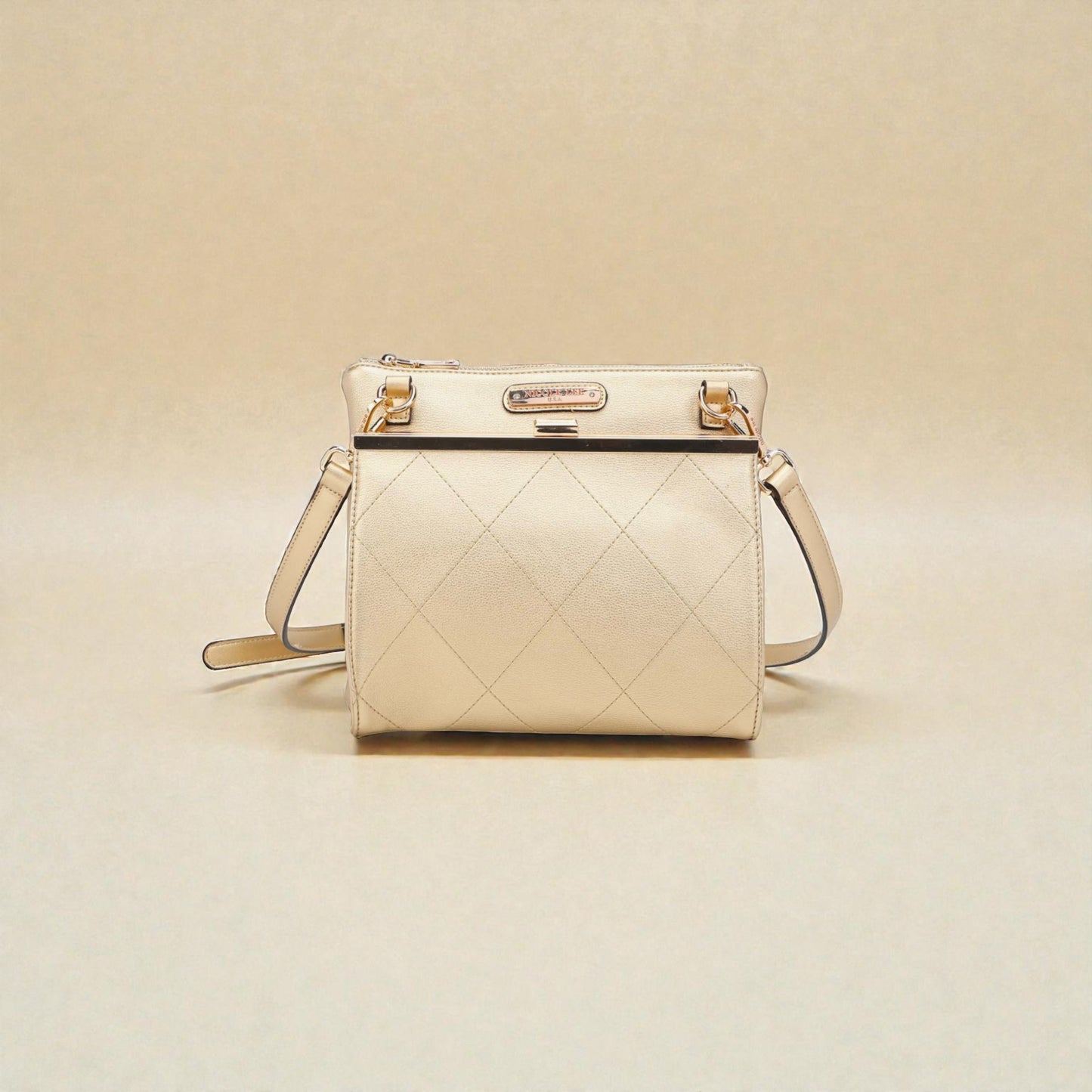 Beige quilted handbag on a beige background