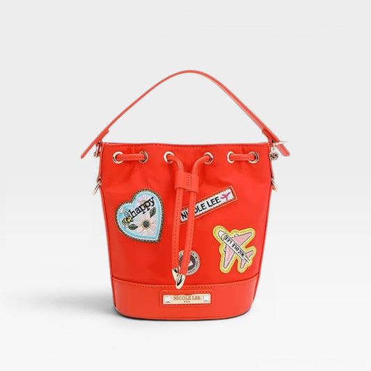 Red bucket bag with patches on a light gray background