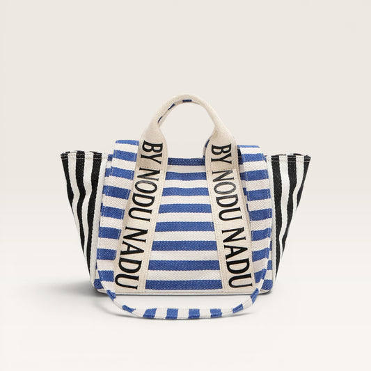 Striped bag with 'BY NODU NADU' branding on a light gray background
