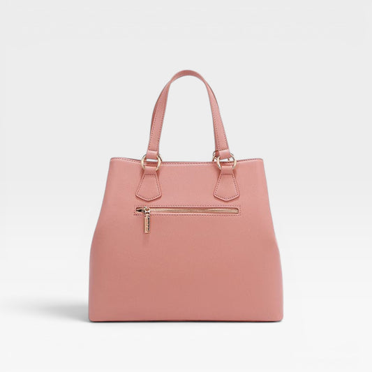 Pink handbag with gold zipper on a light gray background