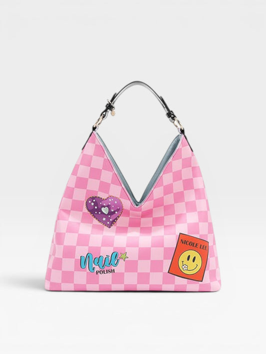Pink checkered handbag with heart and smiley face patches on a white background