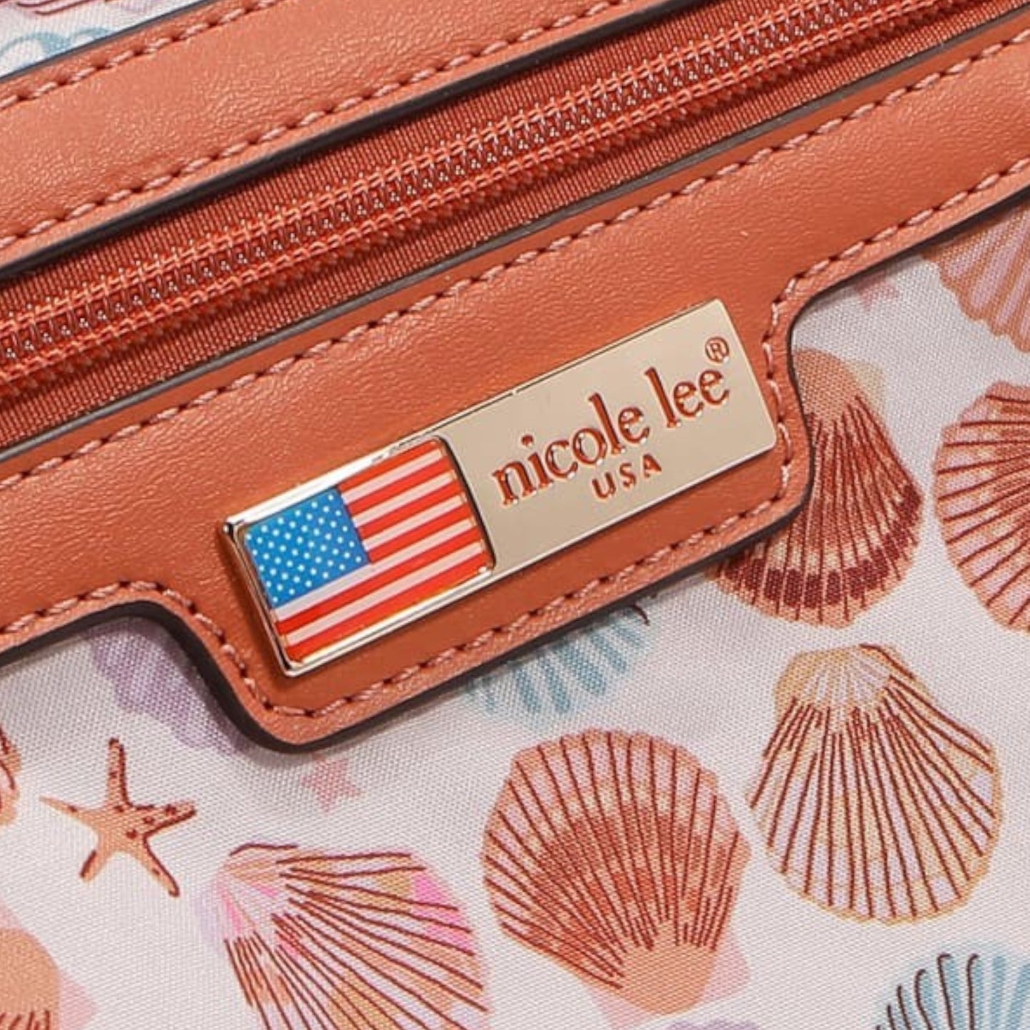 Brown leather product with 'nicole lee' brand name and American flag emblem on a shell-patterned background.