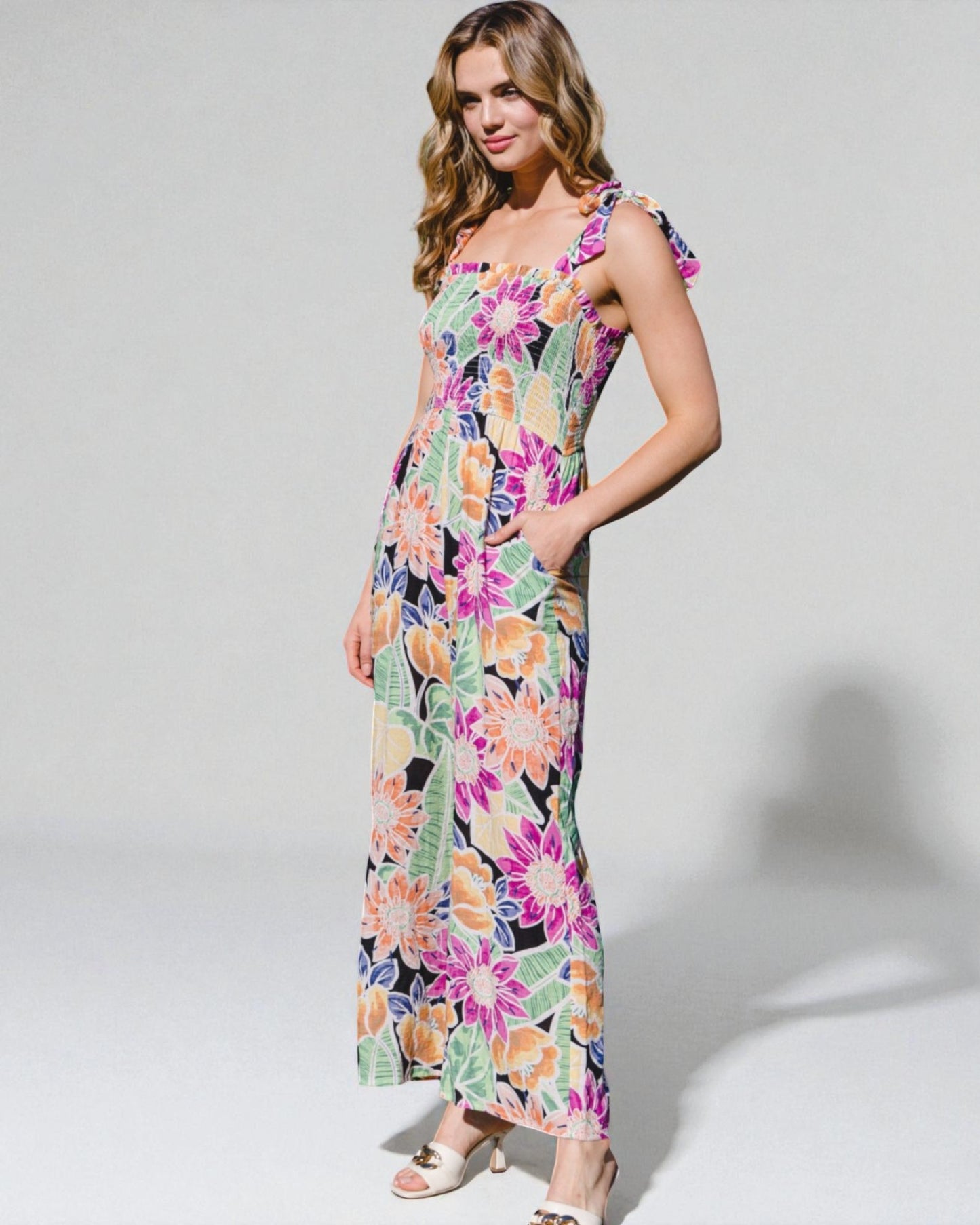 Woman wearing a colorful floral dress on a white background