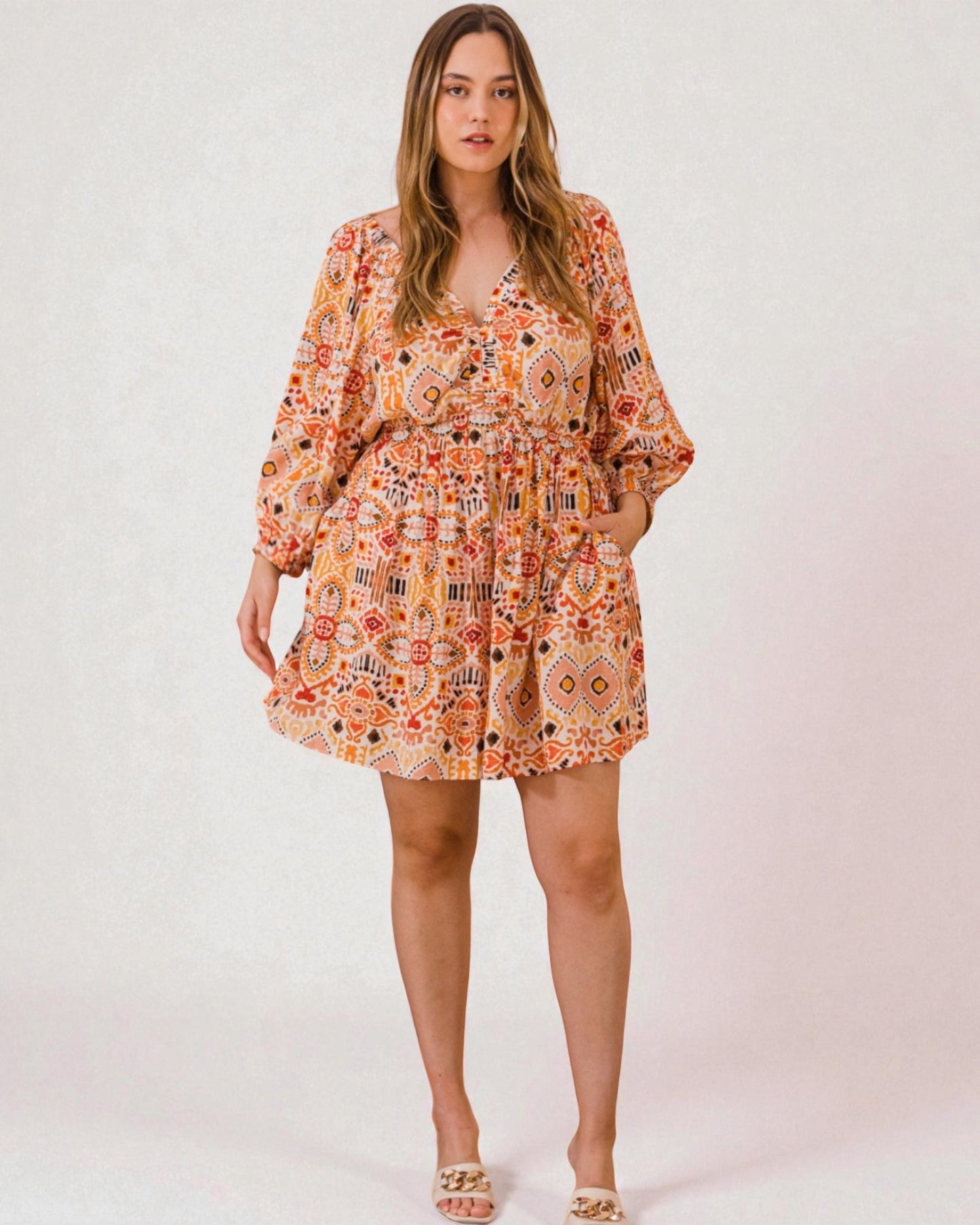 Woman wearing a patterned dress on a white background