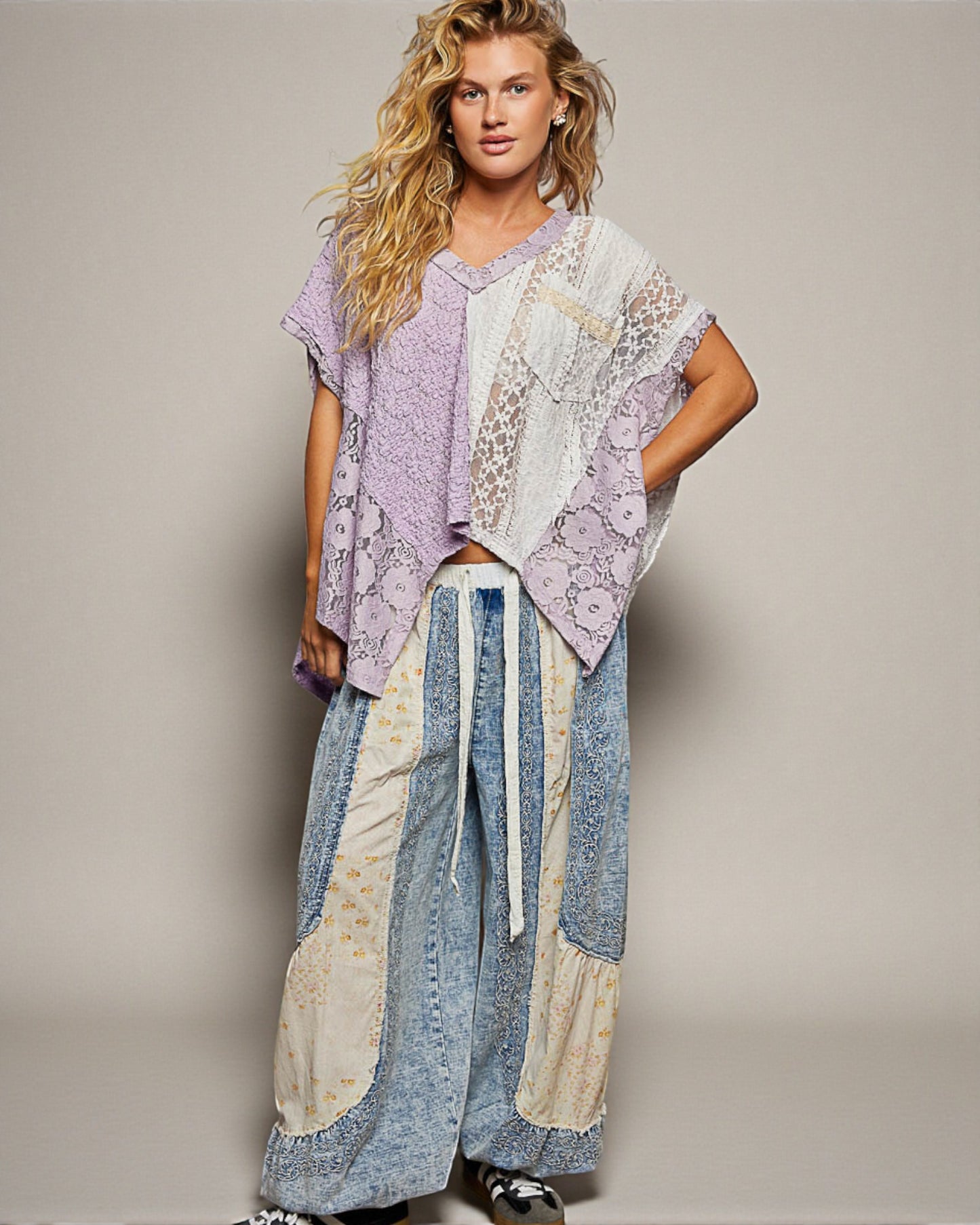 Woman wearing a patchwork outfit with a plain background