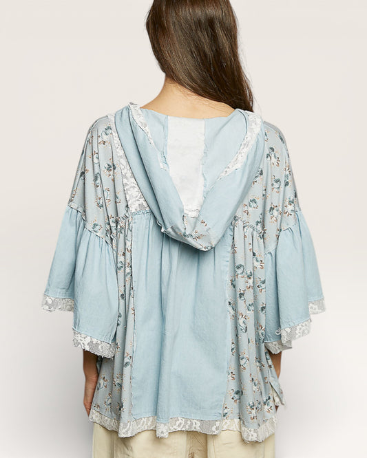 Light blue floral kimono-style top worn by a person on a plain background