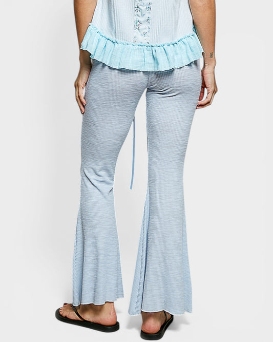 Light blue striped pants worn by a person on a white background