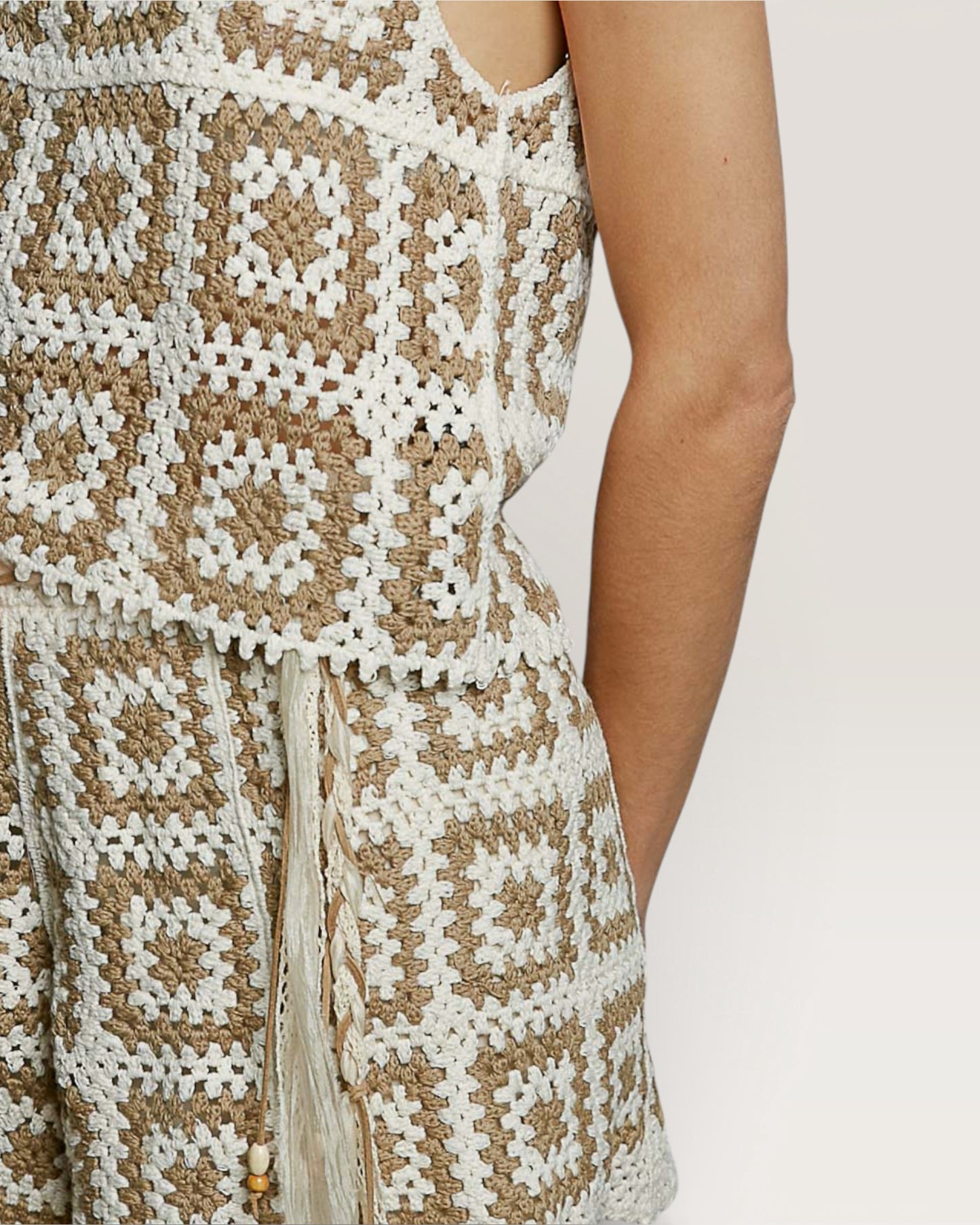 Close-up of a person wearing a patterned dress with geometric design.