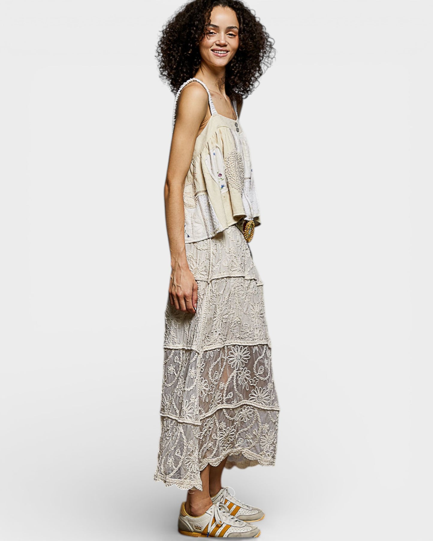 Woman wearing a patterned dress on a white background