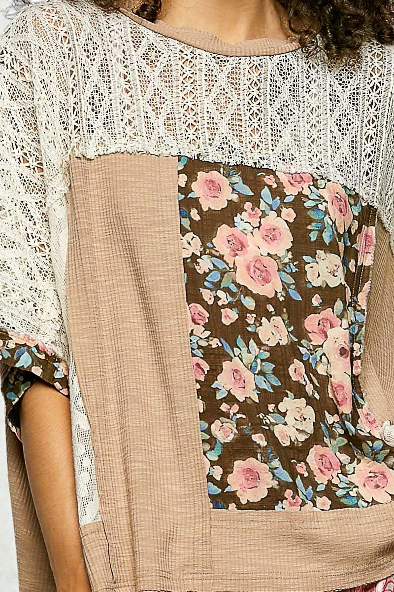 Close-up of a person wearing a floral patterned garment with a lace top.