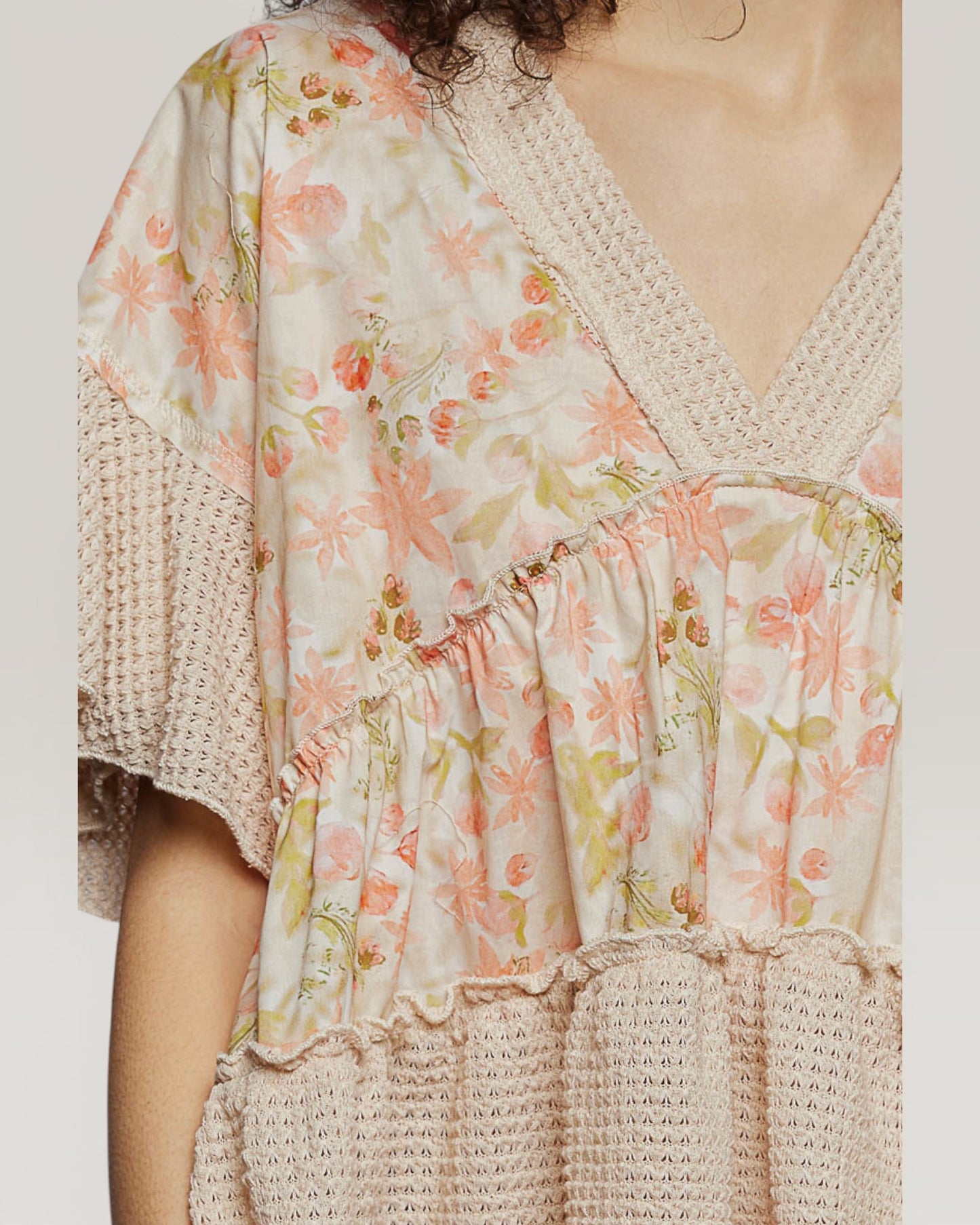 Floral dress with a textured overlay on a plain background