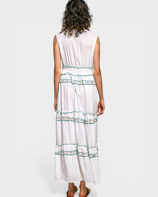 Woman wearing a white dress with green trim on a white background