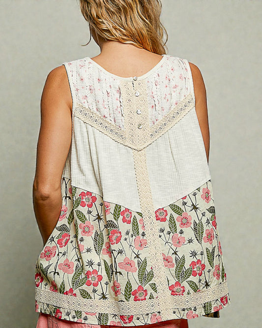 Woman wearing a sleeveless floral top with a neutral background