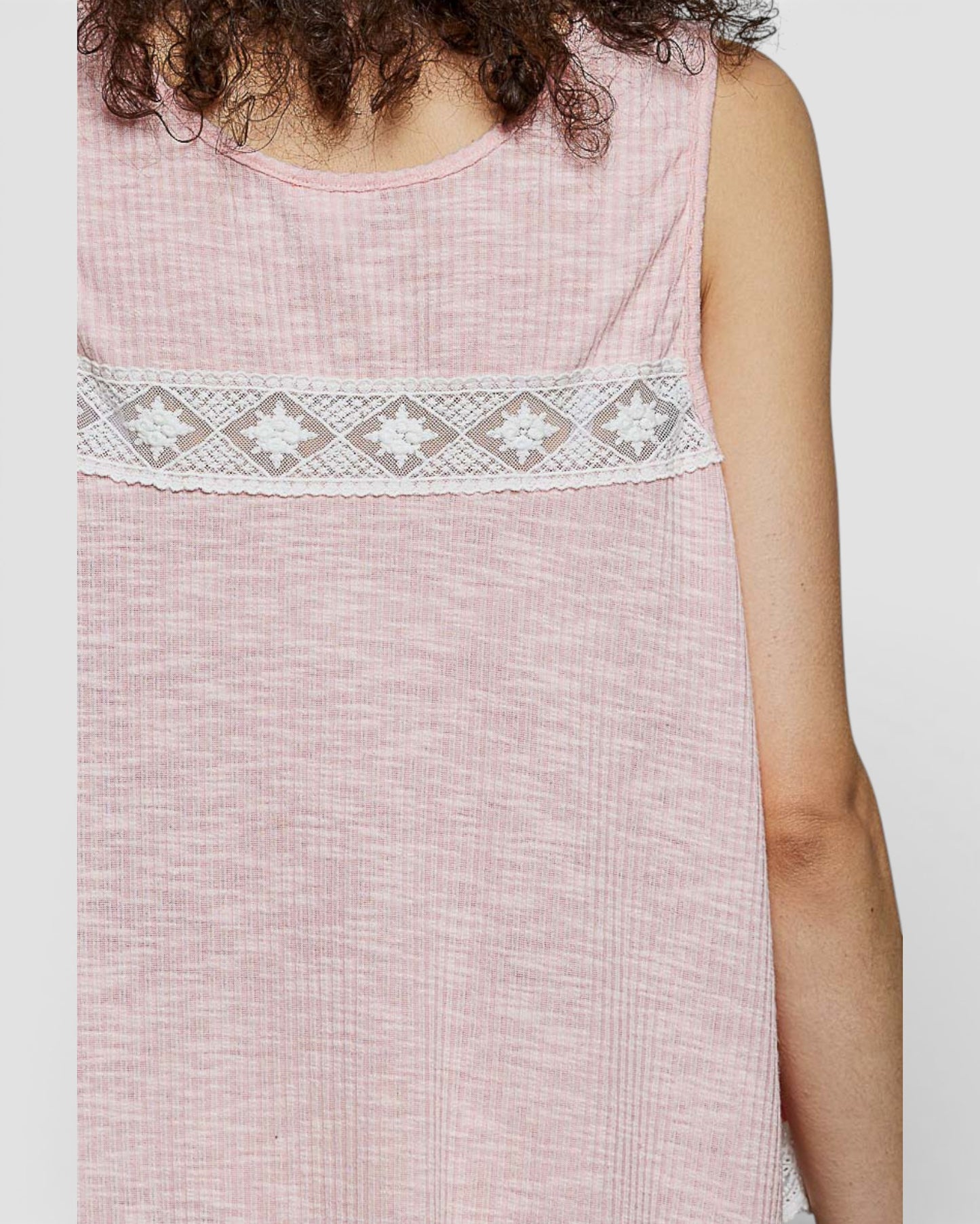Pink sleeveless top with lace detail on a white background