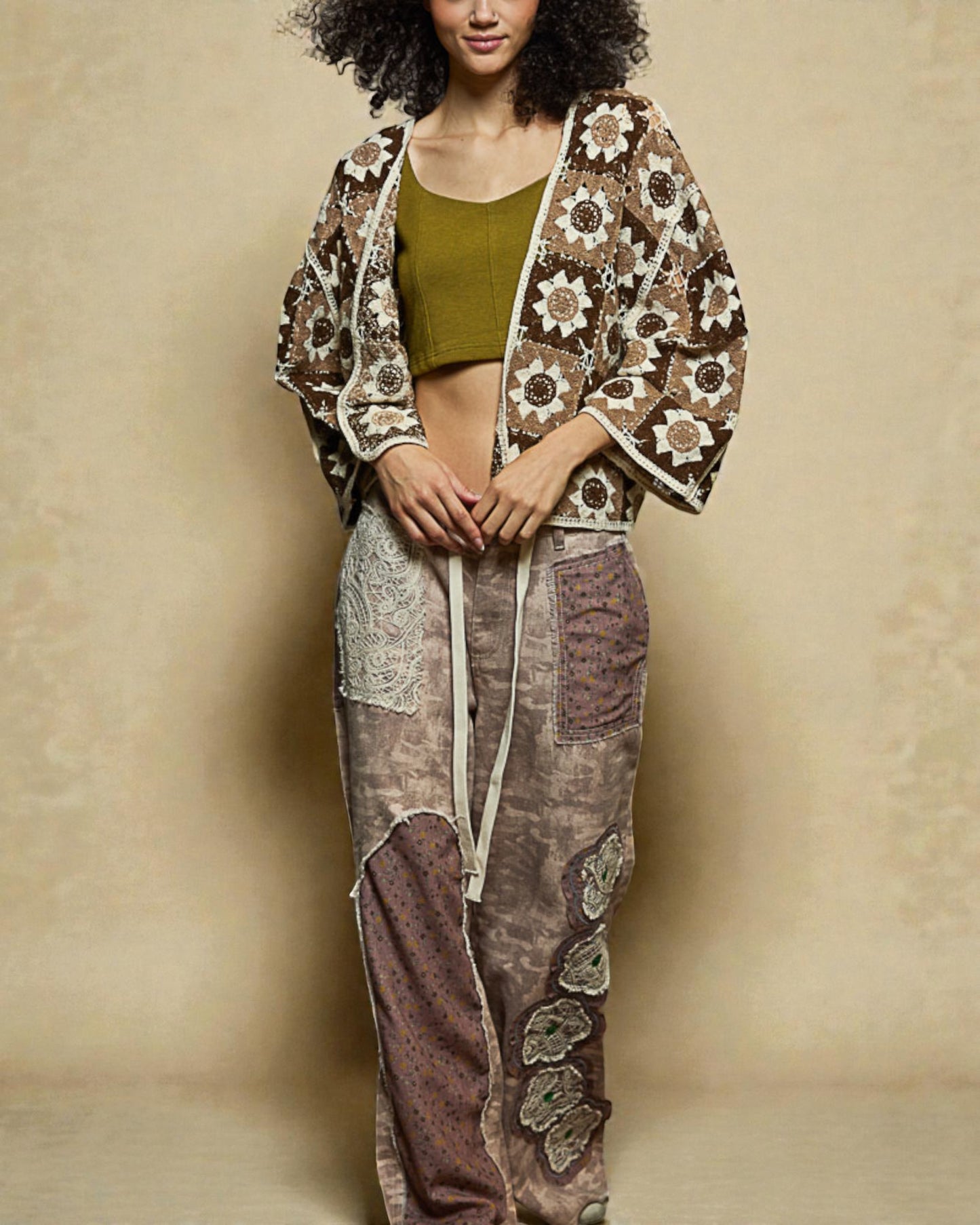 Woman wearing a patterned outfit with a beige background