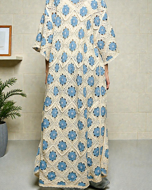 Long floral dress with blue patterns on a neutral background