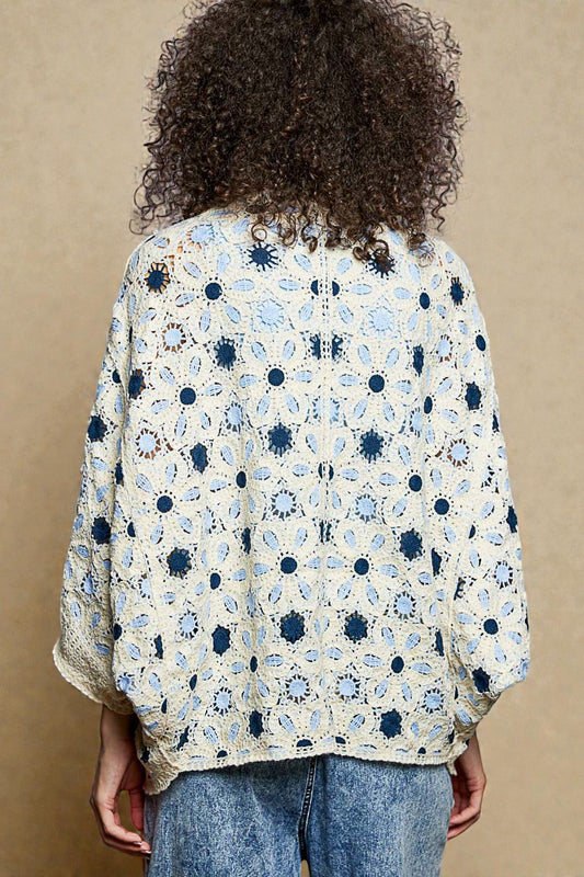 Person wearing a floral patterned shirt with a beige background