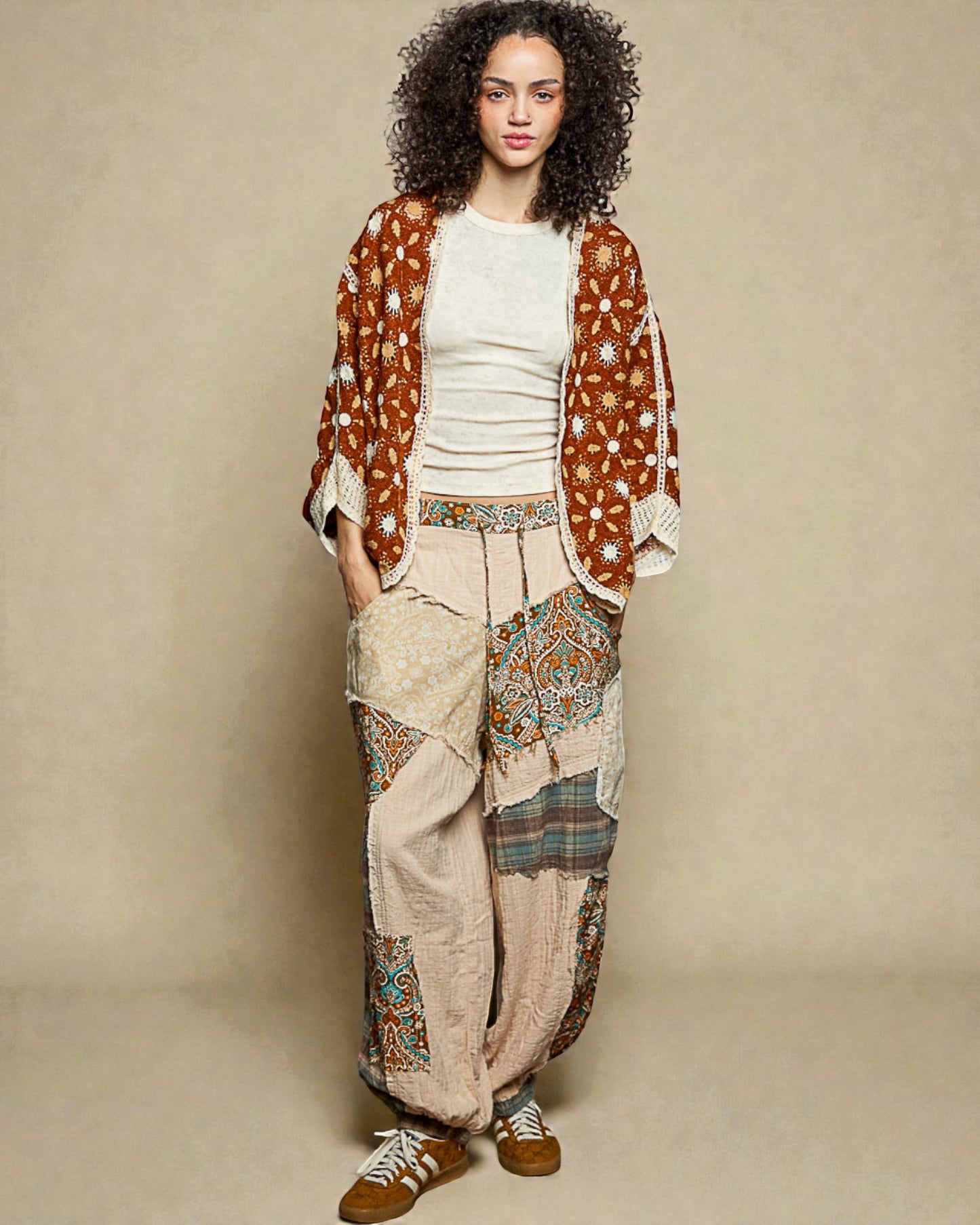 Woman wearing a patterned outfit with a beige background