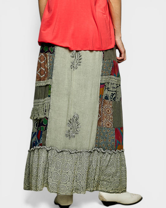 Long, patterned skirt with a person wearing a red top on a white background