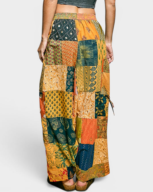 Multicolored patchwork pants worn by a person on a white background
