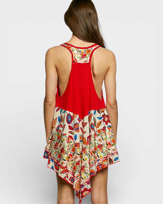 Woman wearing a red and floral dress on a white background